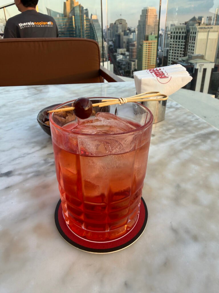 Scarlet Muse Negroni Style Cocktail with Cherry Garnish